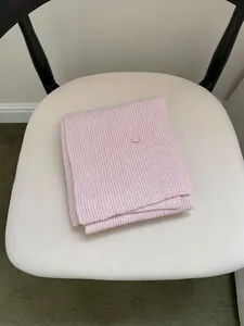 Soft pink ribbed knit scarf with small decorative tag for autumn winter gift set