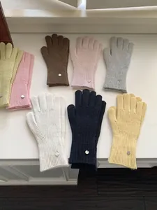 Detailed view of winter warm knitted wool gloves in various stylish solid colors