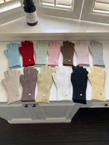 Display of multi-color winter warm knitted wool gloves with decorative metal buttons.
