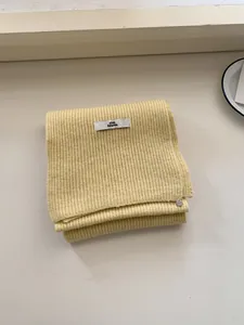 Cozy solid yellow knitted wool scarf with 'pink Dolphin' label for autumn and winter season
