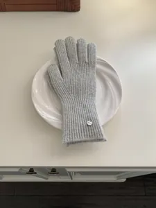 Grey knitted wool gloves for women, warm winter accessory in elegant solid color.