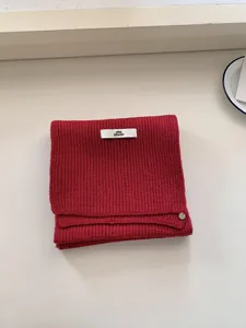 Cozy red knitted wool scarf for women in a classic rib-knit style