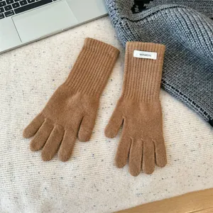 Macro detail of high-quality brown 100% Merino wool knitted gloves for winter warmth.