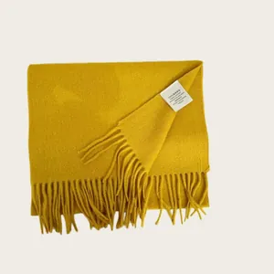 Detail shot of 100% Australian wool scarf with fringed edges in vibrant yellow