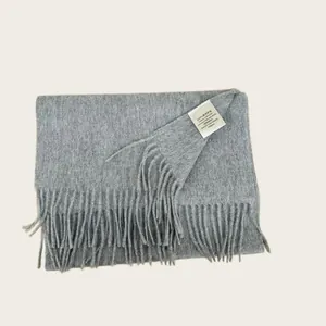 Detailed view of a premium 100% Australian wool scarf with care label and fringe.