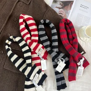 Detailed macro view of soft wool blend striped scarves available in four elegant colors