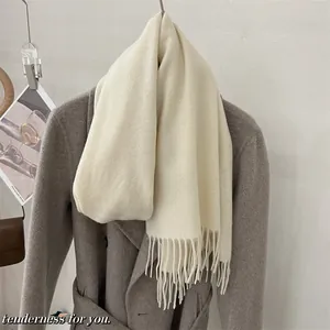 Gros plan d'une écharpe en laine 100% australienne crème avec des franges élégantes
