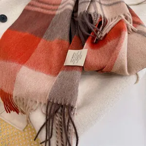 Close-up of 100% Australian wool scarf featuring vintage plaid pattern and tassels