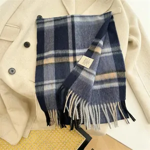 Detailed view of a vintage checkered scarf made of 100% Australian wool with soft fringes.