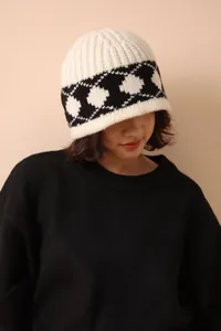 Asian woman wearing a vintage Nordic argyle knit wool beanie in cream and black tones
