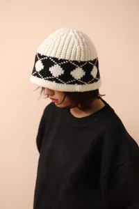 Detailed side view of Nordic vintage diamond pattern wool knit hat worn by model