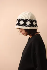 Side view of woman wearing a thick Nordic retro argyle knitted wool bucket hat