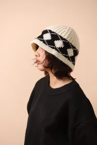 Detailed side view of a vintage black and white argyle pattern wool knitted bucket hat