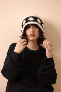 Asian model styling a retro black and white checkered thick wool knit bucket hat
