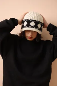 Close-up of Nordic retro diamond pattern 100% wool knit bucket hat worn by model