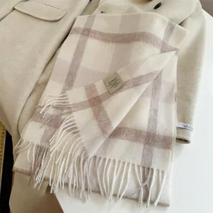 Close-up detail of a premium 100% Australian wool checkered scarf with soft fringes