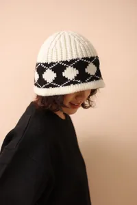 Close-up of retro argyle knitted wool bucket hat with soft knit texture detail.