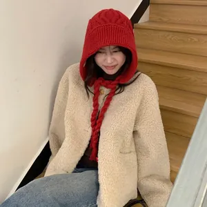 Stylish red thick knitted winter hood with braided ties for warmth and face slimming