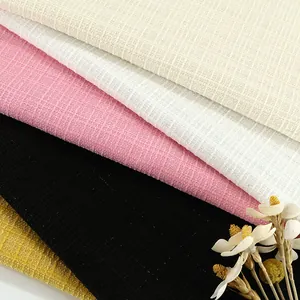 Close-up of multi-colored tweed plaid fabric with elegant texture and subtle shimmer.
