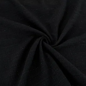 Macro view of black bouclé tweed fabric with subtle sparkles and grid texture