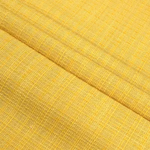 Close-up detail showing the intricate checkered texture of yellow tweed clothing fabric