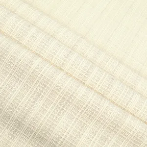 Macro view of cream checkered tweed fabric showing detailed woven texture for autumn fashion.