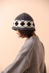 Side profile of a premium thick grey Nordic argyle pattern wool knit beanie for women