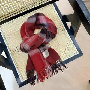 Close-up of a red plaid Australian wool scarf with tassels on a vintage chair.