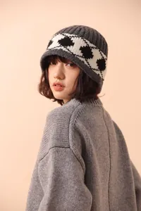 Vintage Nordic diamond pattern knit wool beanie hat for women shown on a model