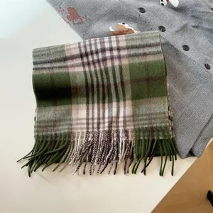 Detailed view of vintage green plaid wool scarf showcasing soft texture and tassels