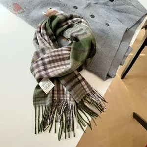 Detail of 100% Australian wool plaid scarf with tassel in green and brown