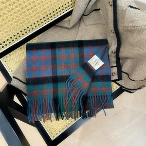 Detail showing 100% Australian wool label on a blue and green tartan scarf
