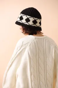 Detailed view of the thick wool bucket hat with retro diamond pattern on a model