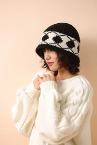 Close-up showing the texture and Nordic diamond pattern of the knitted wool bucket hat