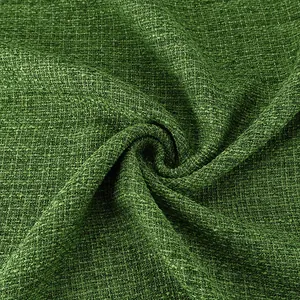 Close-up detail of luxury green tweed fabric with shimmering silver metallic threads