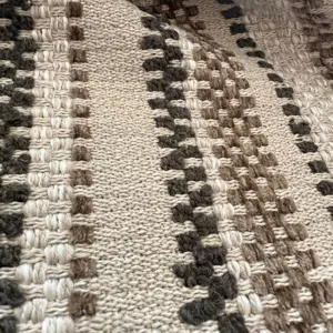 Close-up detail of retro jacquard woven fabric with neutral brown and beige patterns