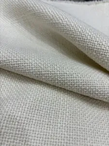 Close-up macro view showing the natural woven texture of premium white linen cotton fabric