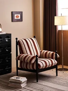 Cozy mid-century modern armchair with vertical stripes in a warm living room setting