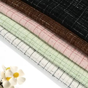 Close-up macro of multicolored grid tweed fabric showing elegant rough-spun texture