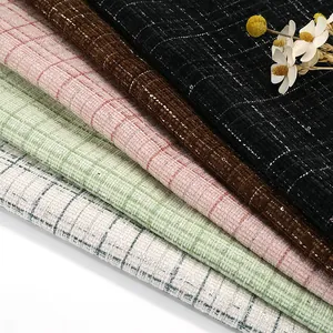 Close-up of multicolored checkered tweed fabric with subtle sequins for elegant coats