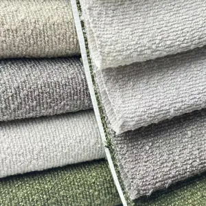 Close-up macro view of thick bouclé upholstery fabric texture showing various color options
