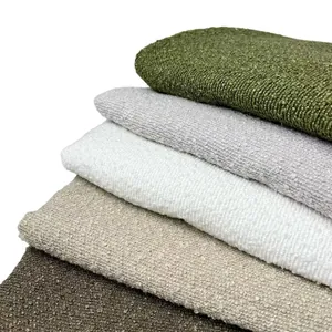 Macro detail of thick boucle yarn fabric stack in diverse neutral and earthy tones.