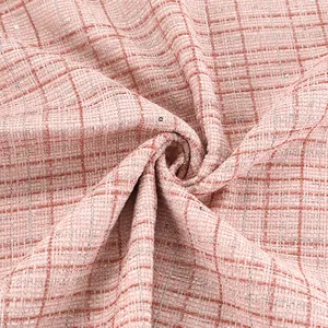 Close-up of pink checkered tweed fabric with sparkling silver sequins for clothing