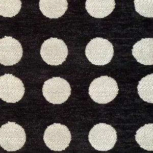 Close-up of thick chenille jacquard fabric with vintage white polka dots on black