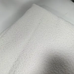 Close-up macro view of high-quality white thick boucle yarn fabric with textured finish