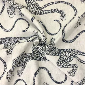 Macro detail of white chenille jacquard fabric featuring a vintage black leopard pattern