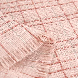 Close-up of pink plaid tweed fabric with metallic silver threads and fringe