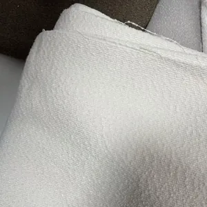 High-quality macro detail of thickened white bouclé yarn fabric with teddy linen texture