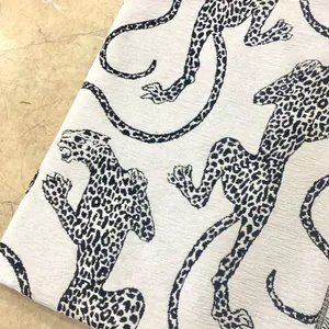 Macro view of white chenille jacquard fabric with blue leopard pattern texture