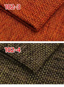 Detailed macro view of thick coarse linen sofa fabric in rust orange and moss green